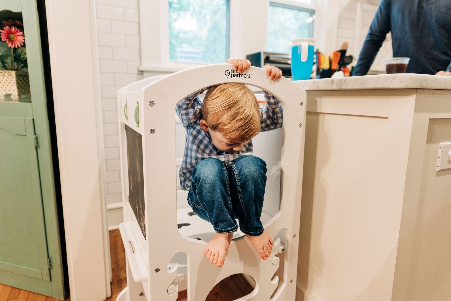 A little boy climbing down from step ladder