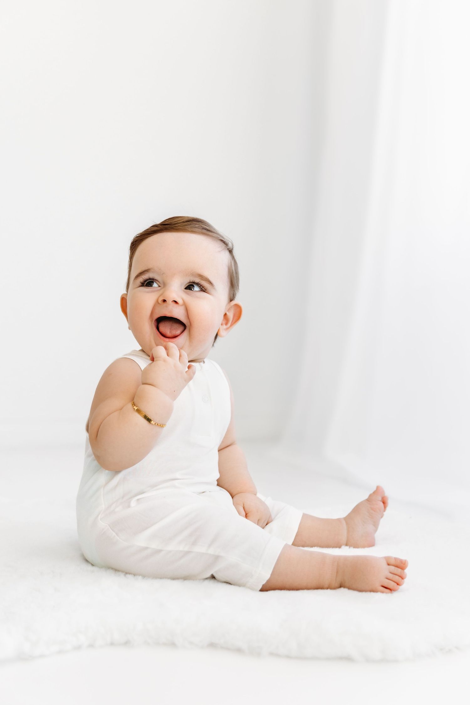 Giggling Happy Baby in White Romper