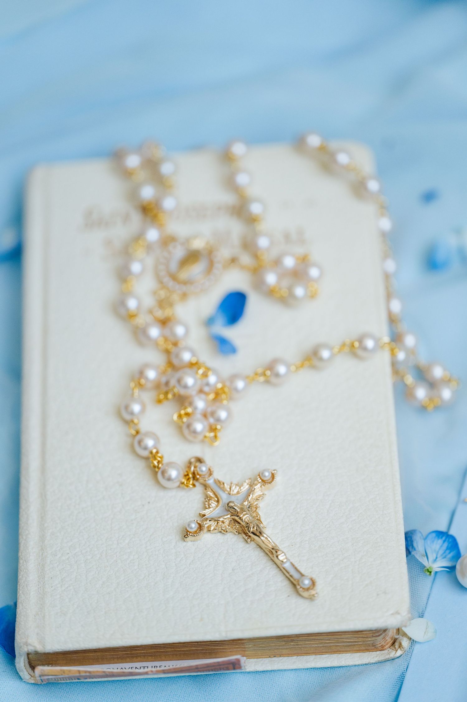 Wedding gold rosary on missal ahead of a Catholic wedding at Parish of christ the King in Tulsa, OK.