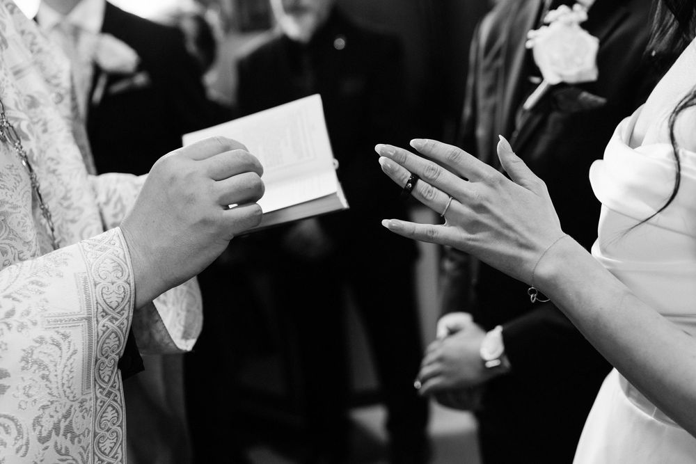 Wedding guests clink champagne glasses together in celebration during an elegant reception toast.