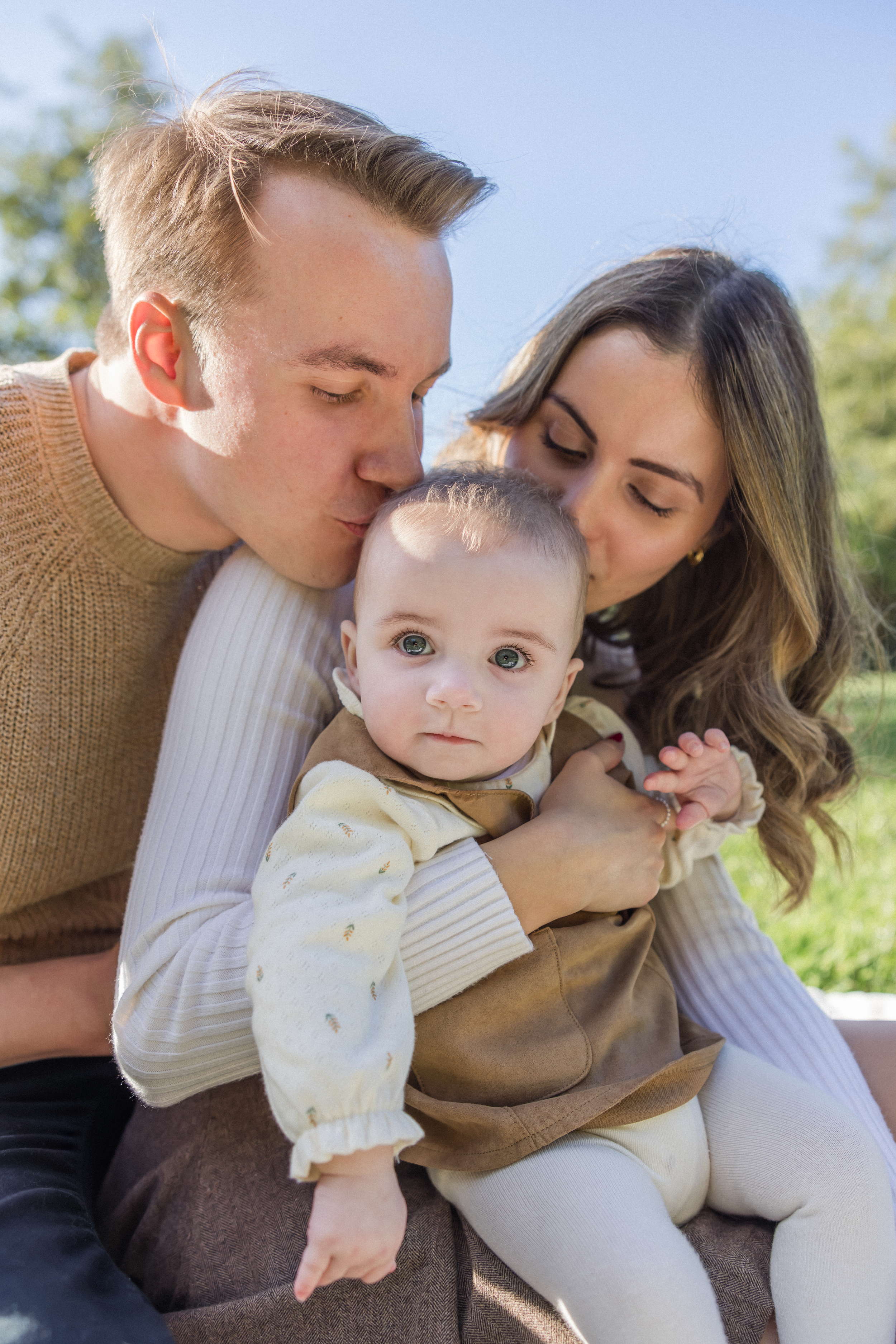 Family Photoshoot with Baby - Parents Kissing Baby