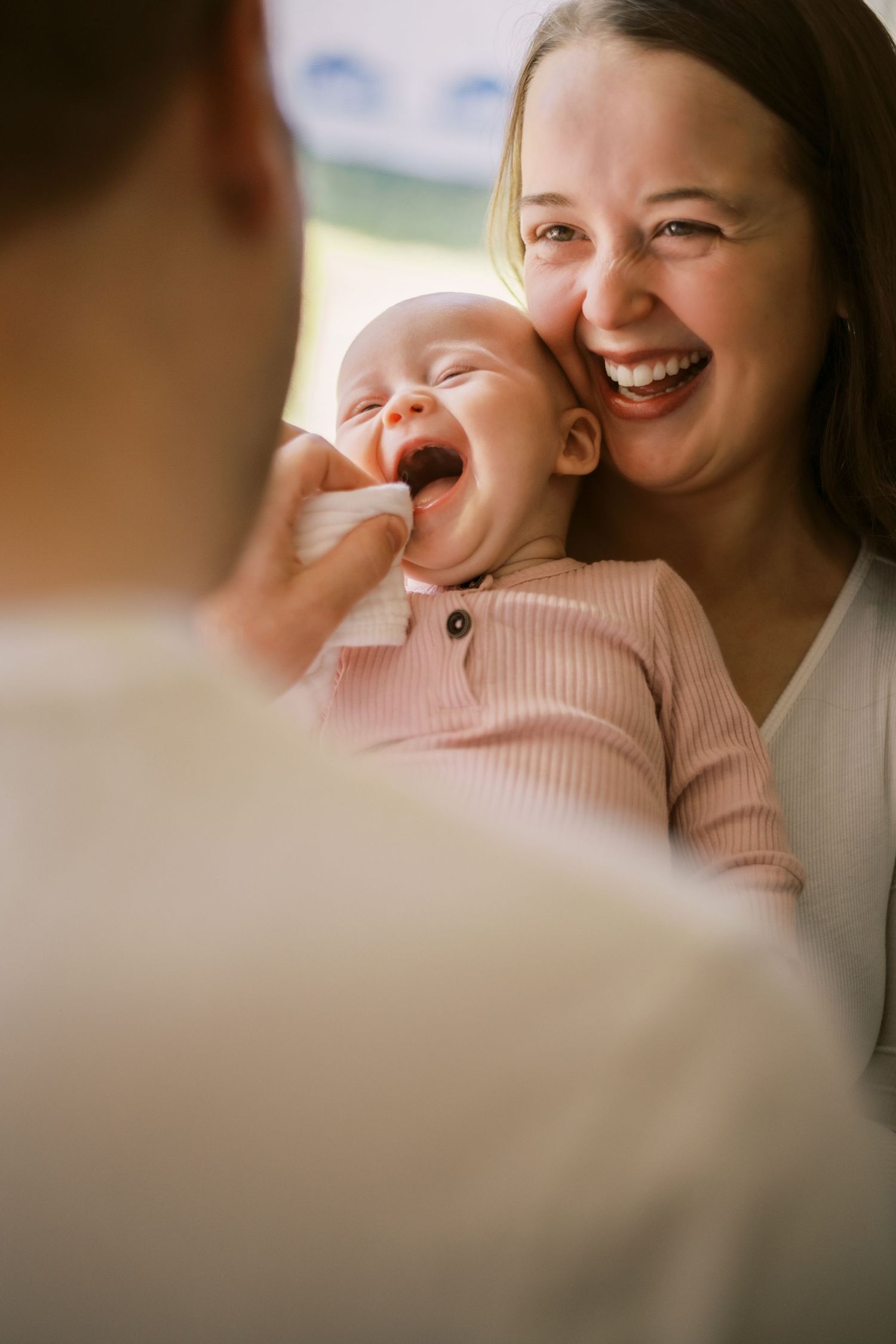 Intimate candid moment of pure joy and laughter shared with a small baby.