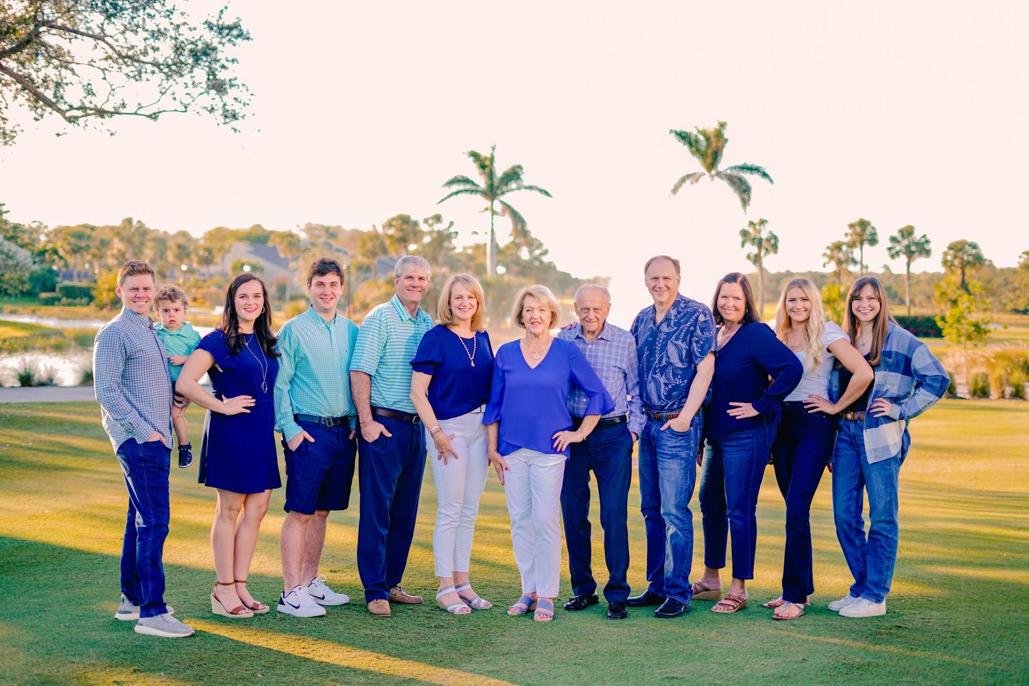 a large family group posed on a golf course in florida