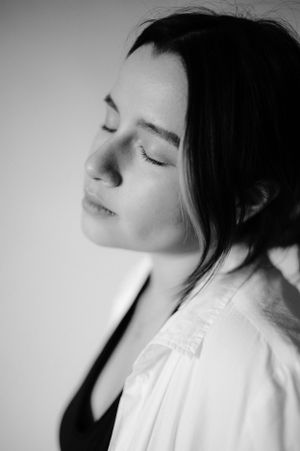 Black and white profile portrait showing peaceful expression and natural lighting.