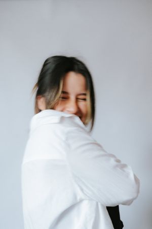 Candid moment captured in white shirt showing genuine joy and movement.