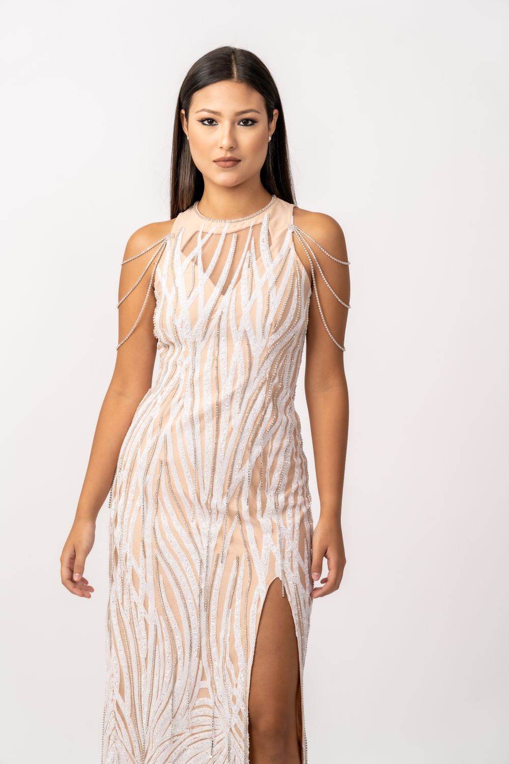 Long fitted dress with beige animal print pattern and shoulder chain details.