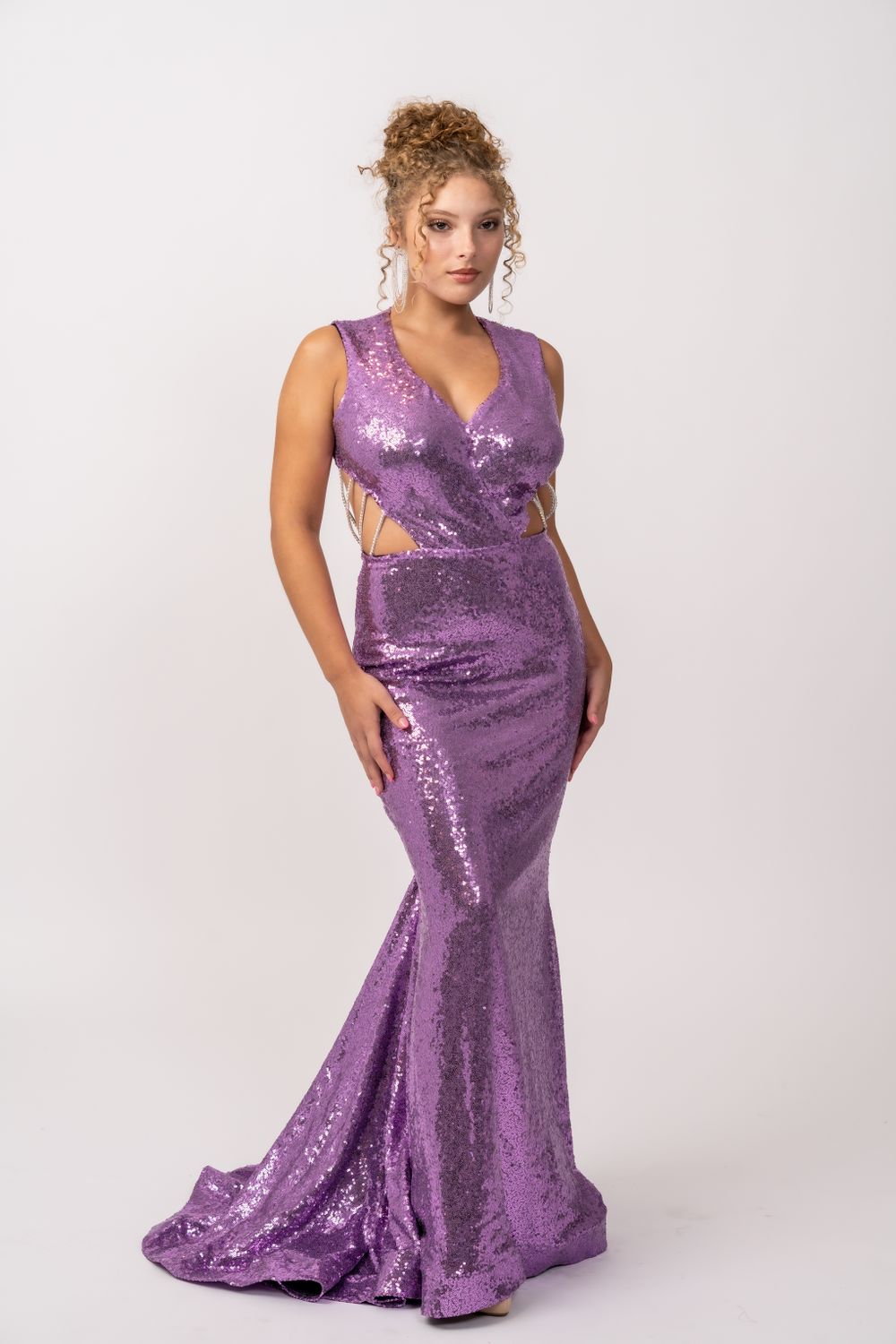 Sparkling purple sequin mermaid gown with side cutouts and train.