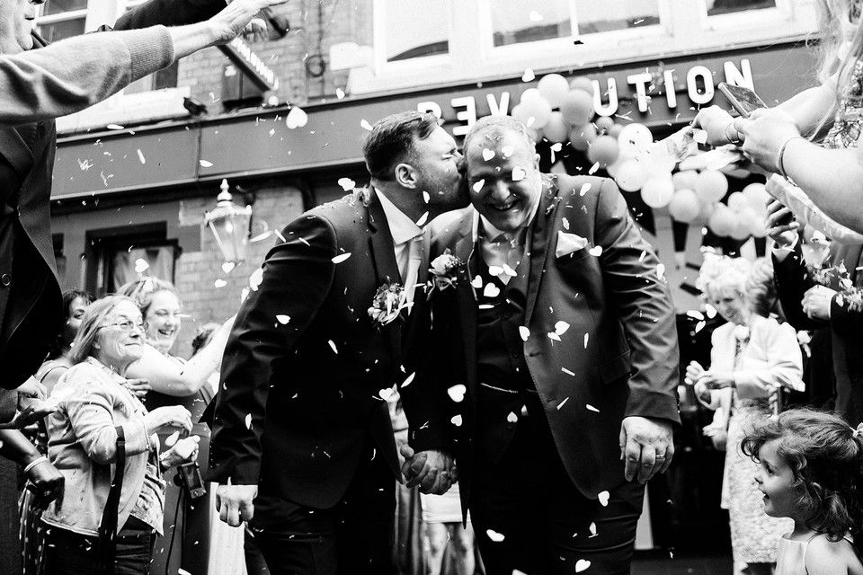 A celebratory moment with confetti falling at an outdoor gathering.