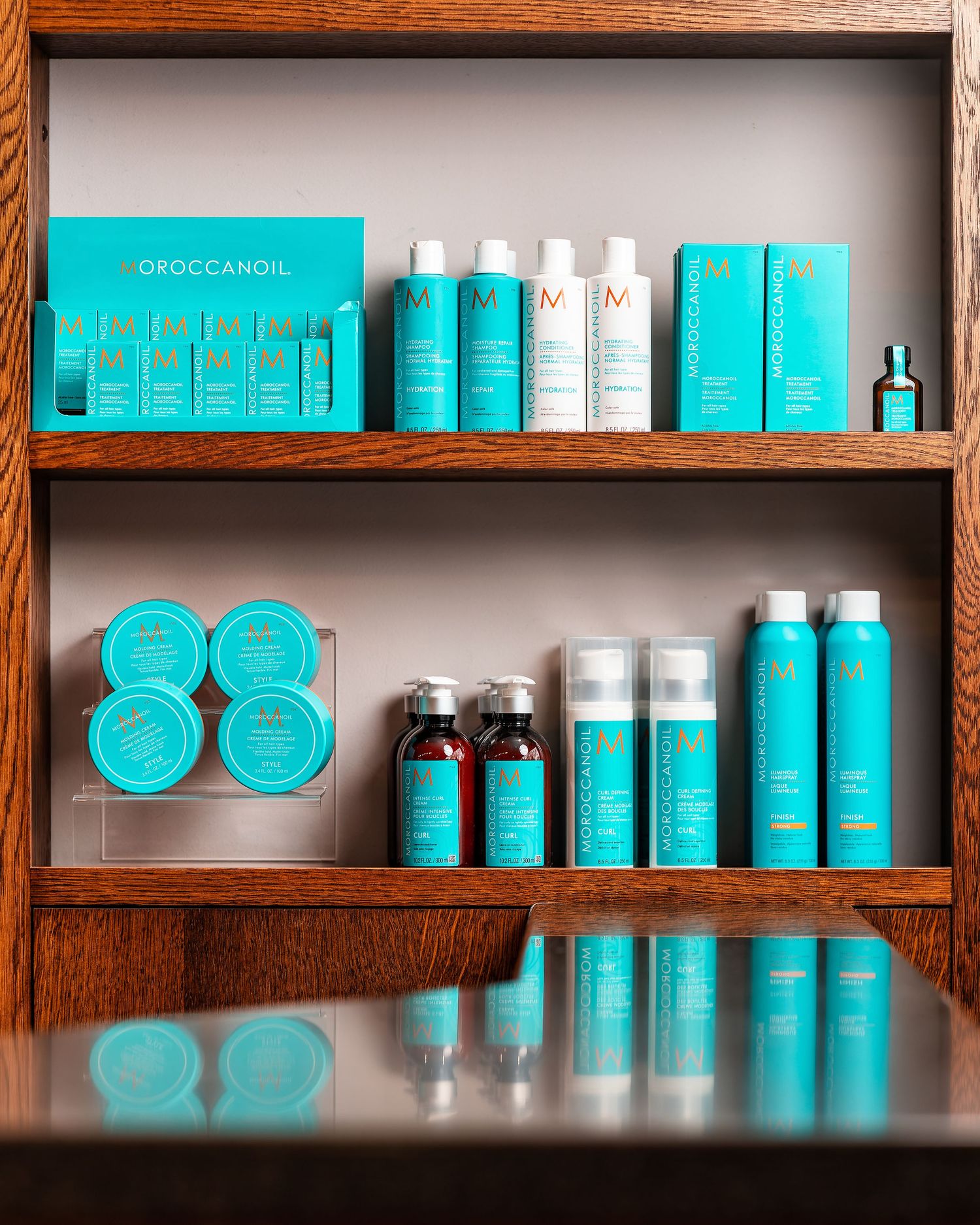 Moroccanoil hair products on wooden shelves at Above Barbers salon Southampton, haircare product display photography