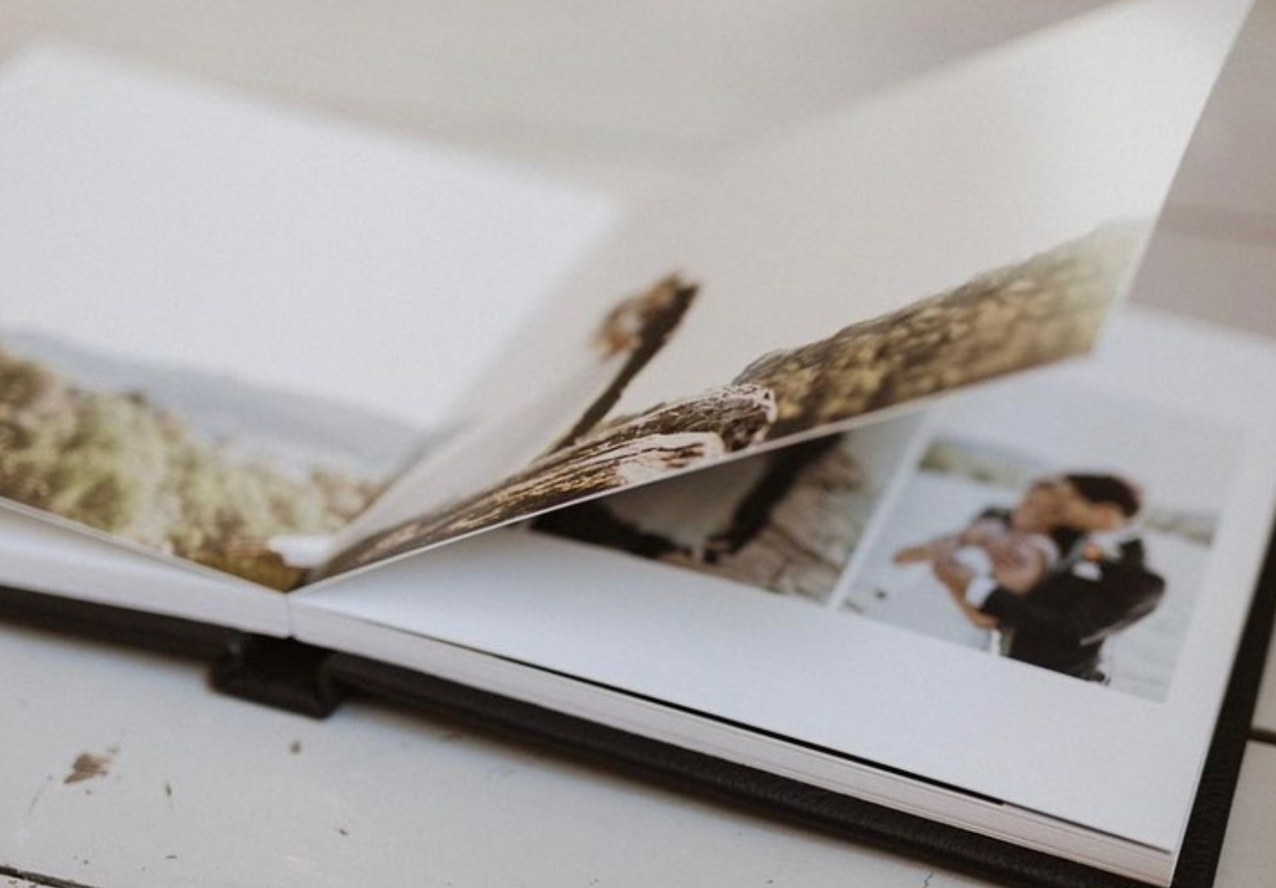 Series of wedding album pages spread out showing photographic layouts.