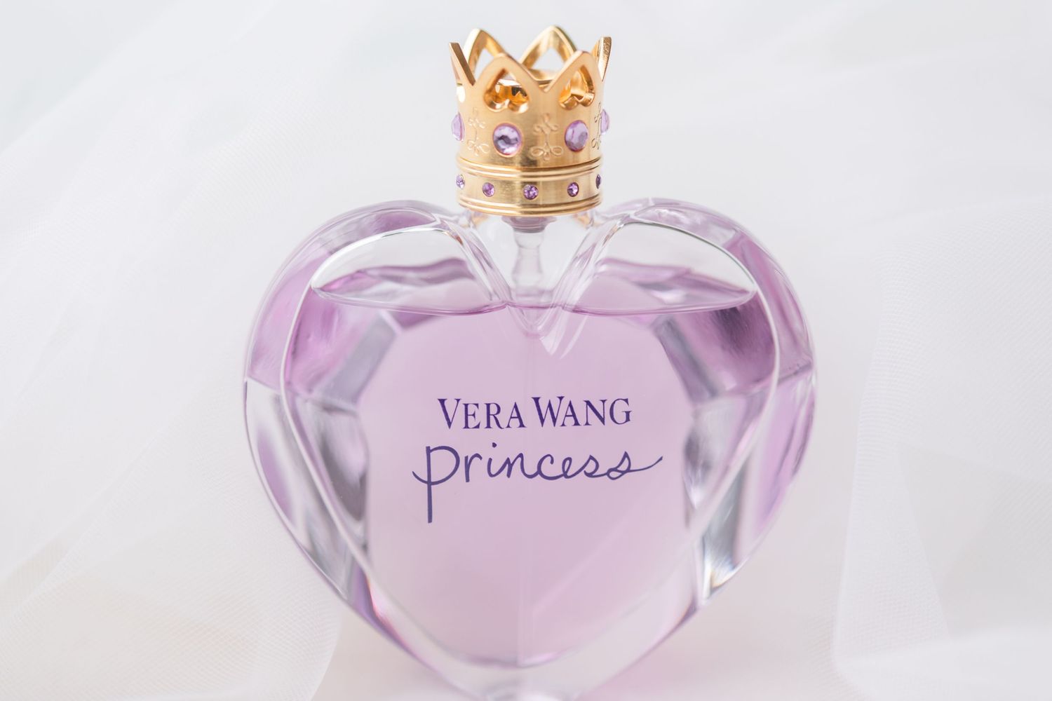 Vera Wang Princess perfume bottle with crown top in soft purple hue.