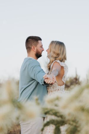 A tender moment between a couple during their desert engagement session.