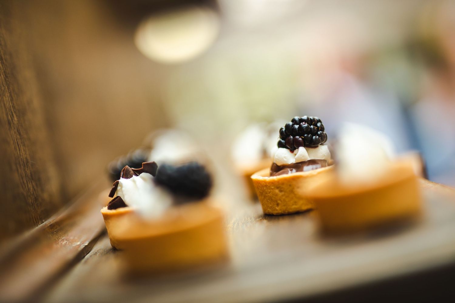 Elegant appetizers featuring black caviar on small toasts arranged on a serving plate with shallow depth of field.