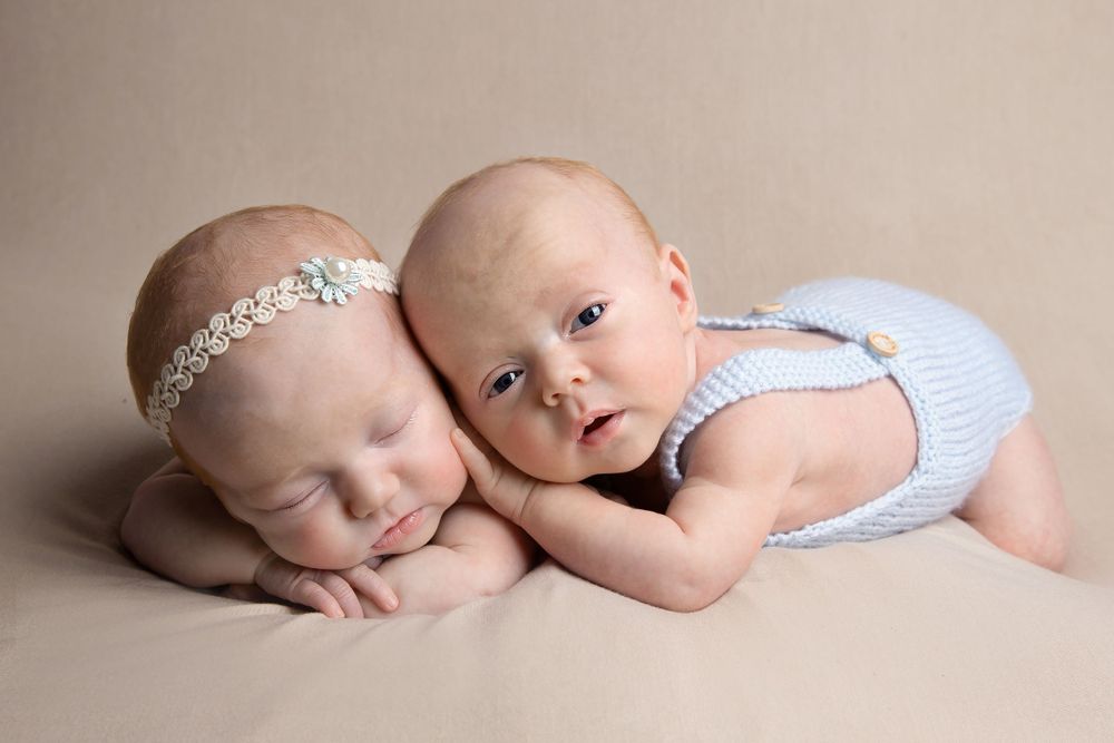 newborn twins photo shoot laid on tummy