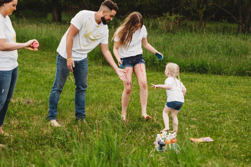Family enjoying outdoor activities together in a grassy field.