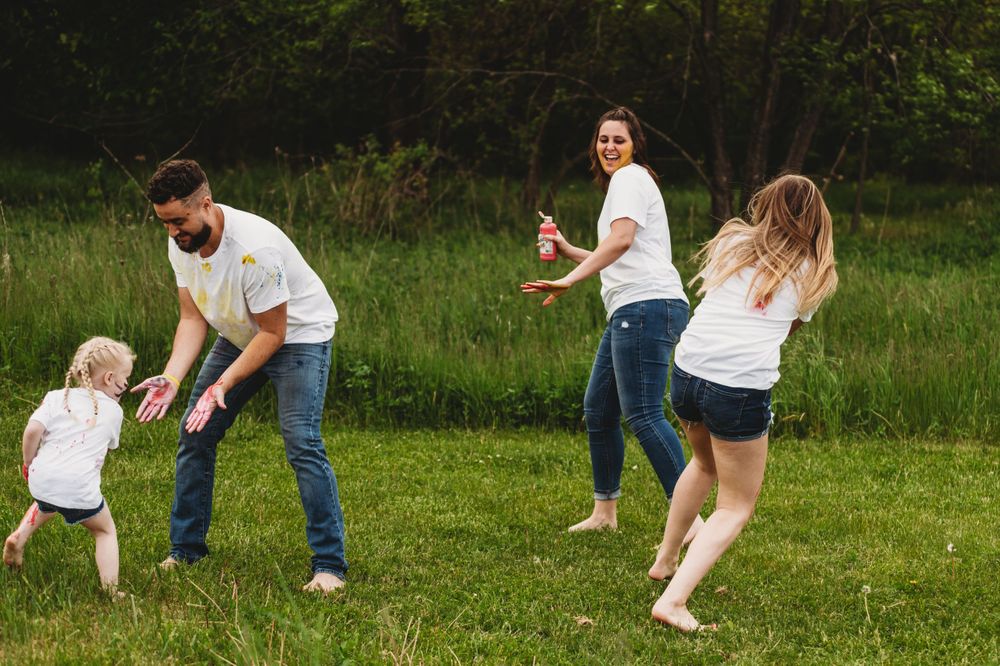 Group playing and running through grass during outdoor activities.