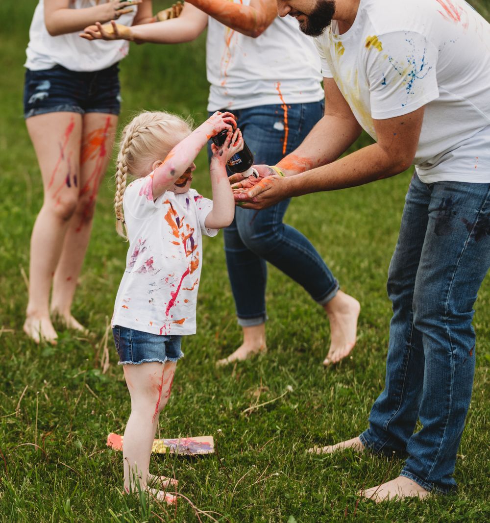 Close-up of feet and legs during outdoor paint play activity.