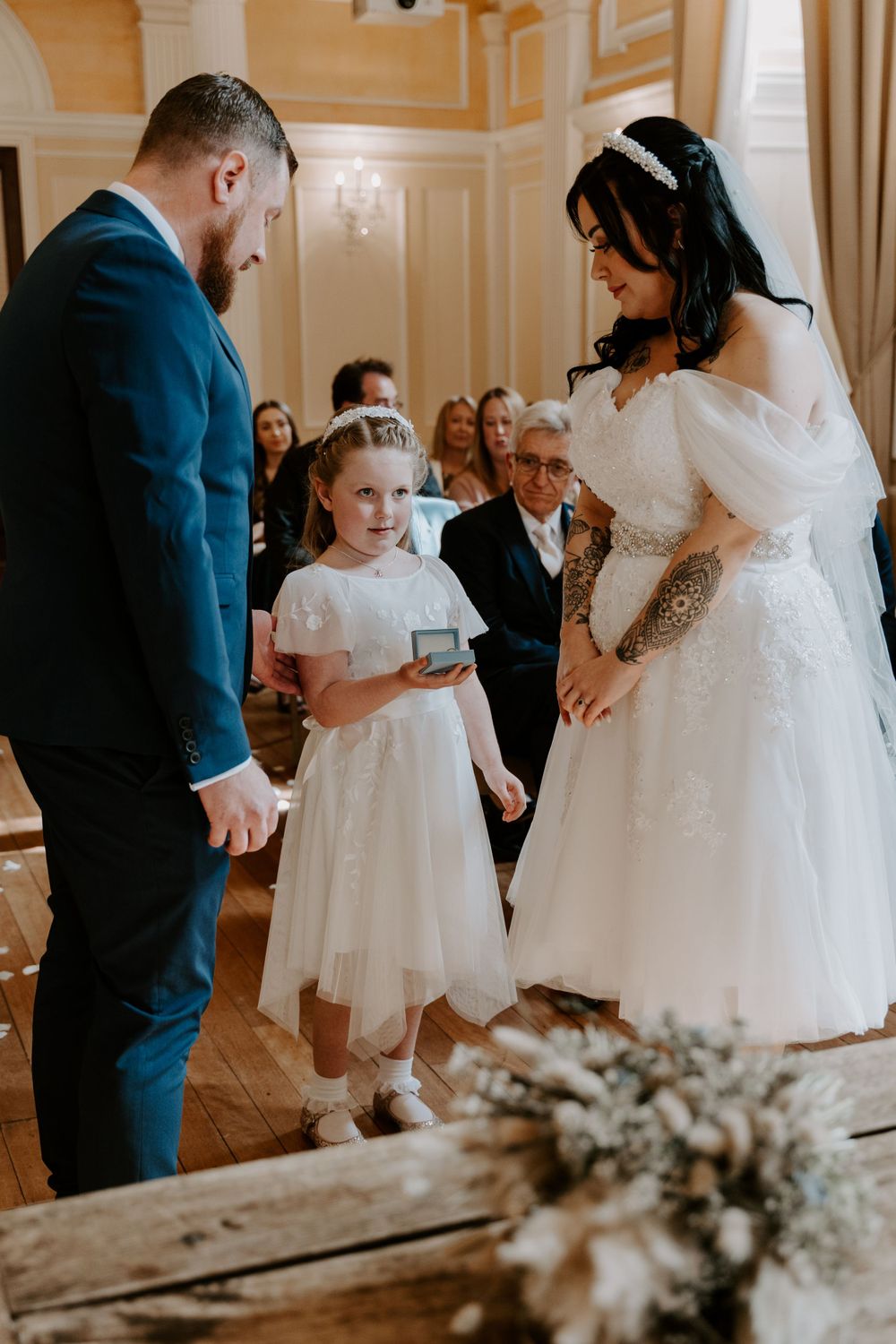 the flower girl bringing the rings up to her parents during their vows.
