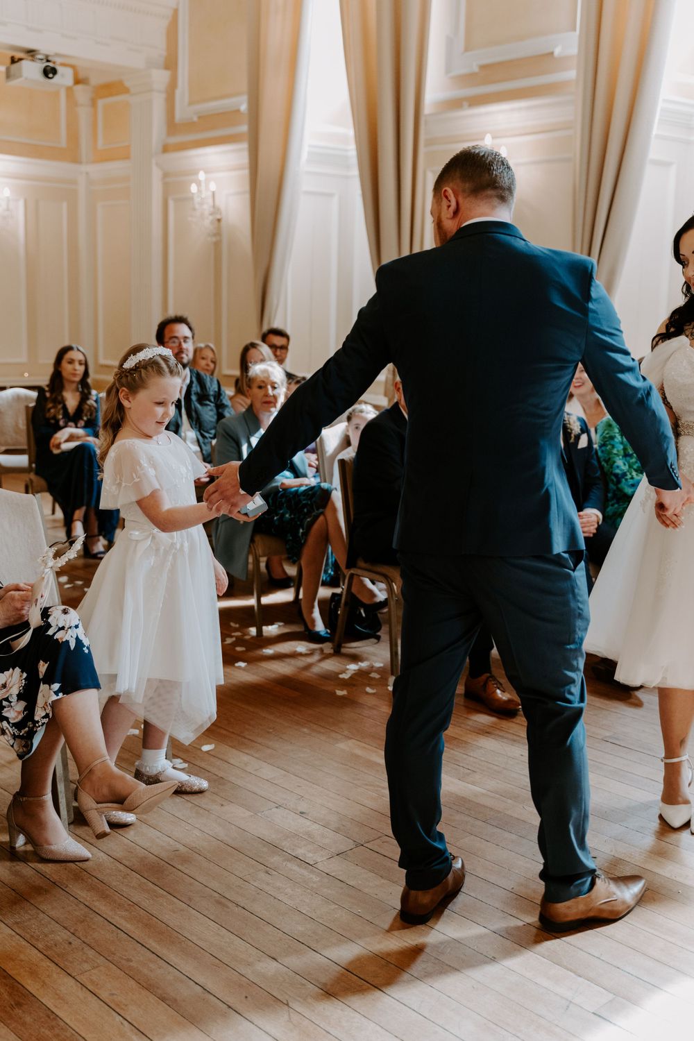 the flower girl bringing the rings up to her parents during their vows.