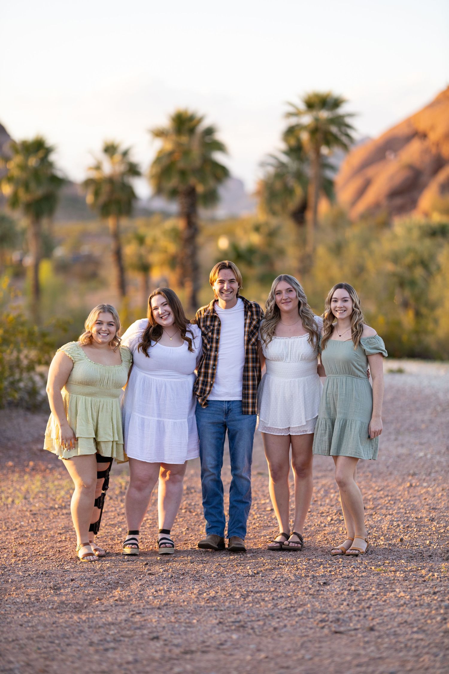 College seniors posing in their friend group smiling at the camera.