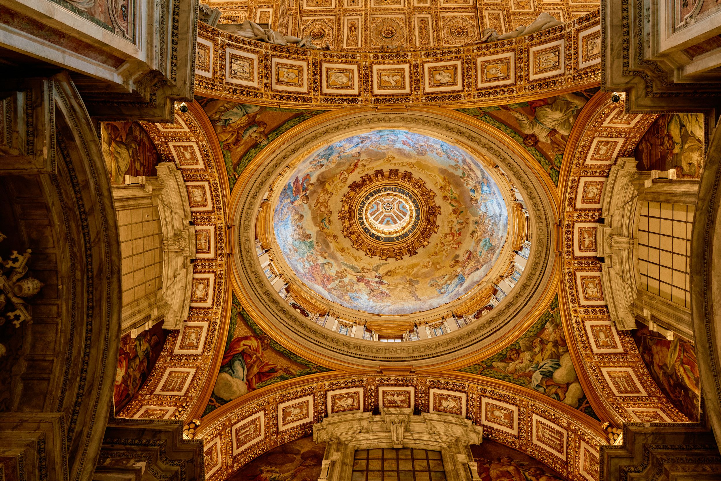 Ornate dome ceiling with religious frescoes and gilded decorations inside Saint Peter's Basilica.