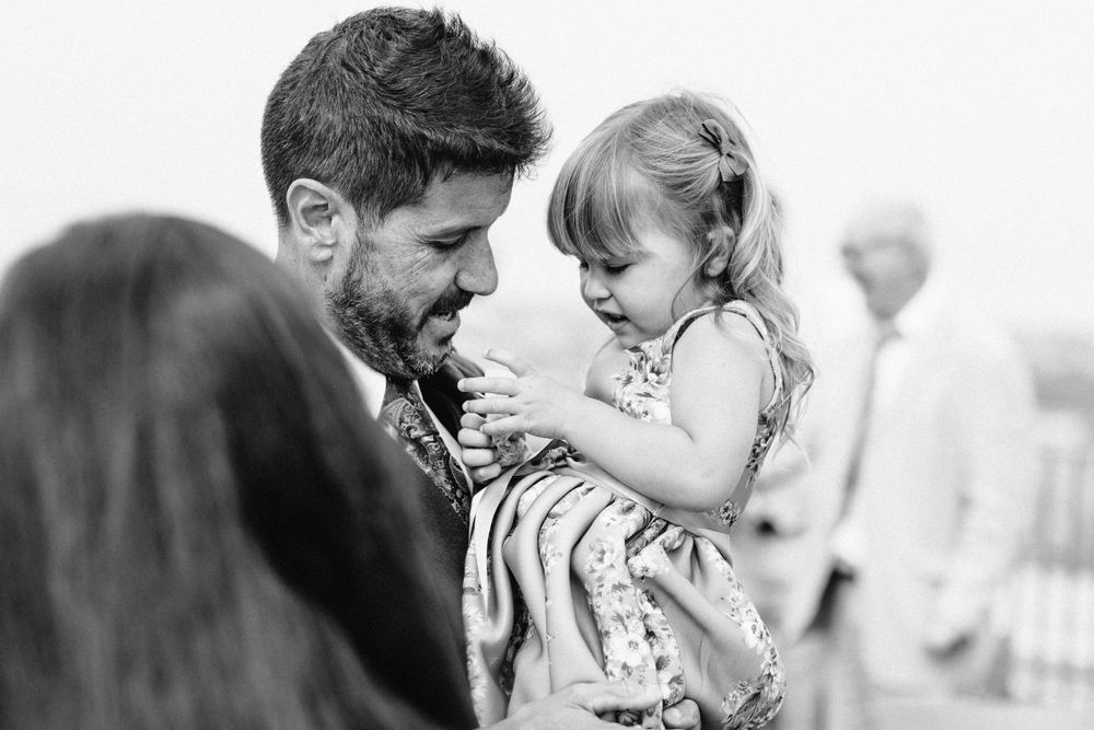 Black and white capture of joyful dancing moments at outdoor wedding celebration.