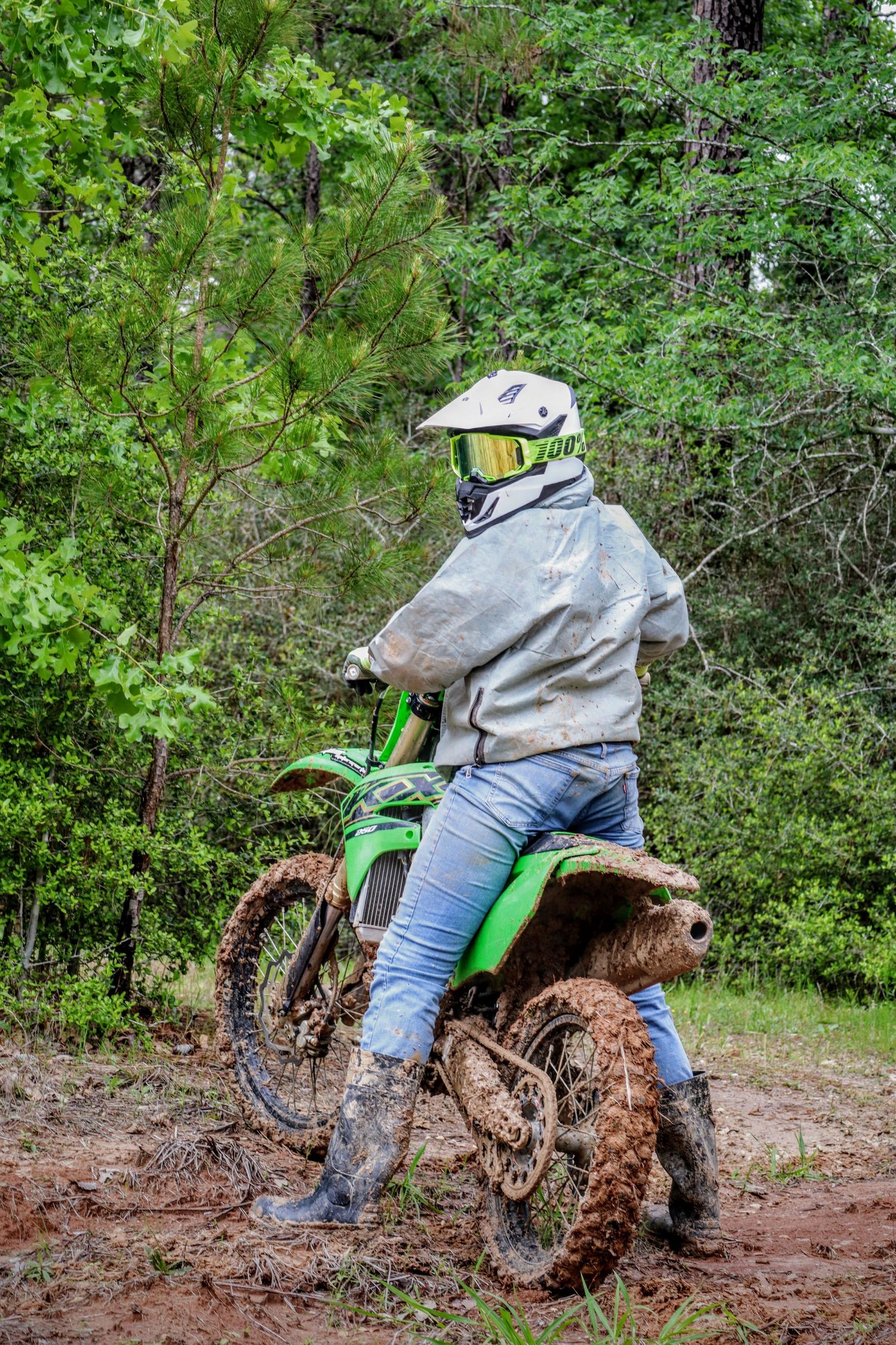 Dirt bike rider splashing through muddy terrain on green motorcycle in sequential action shots.