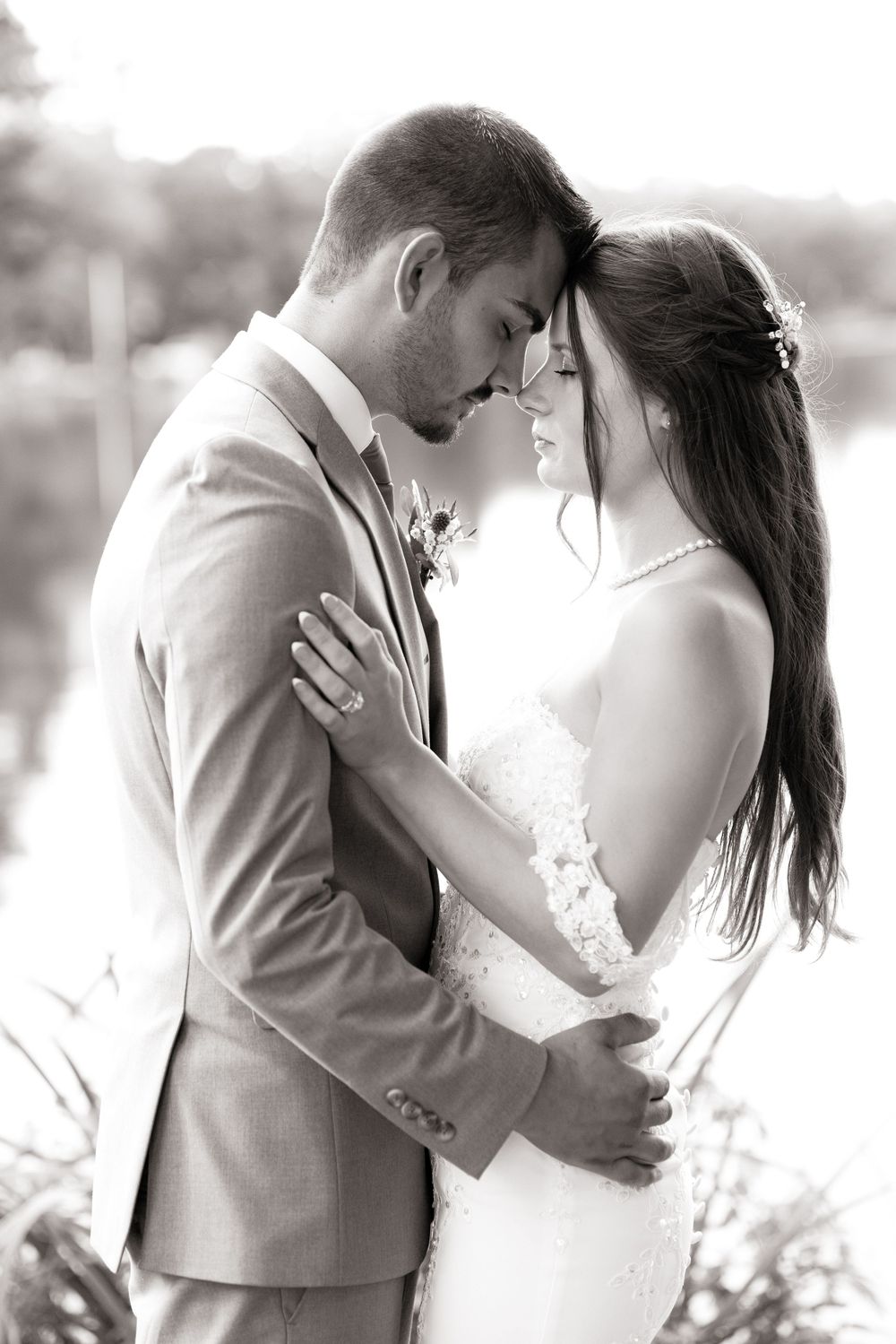 Black and white portrait of intimate wedding moment outdoors.