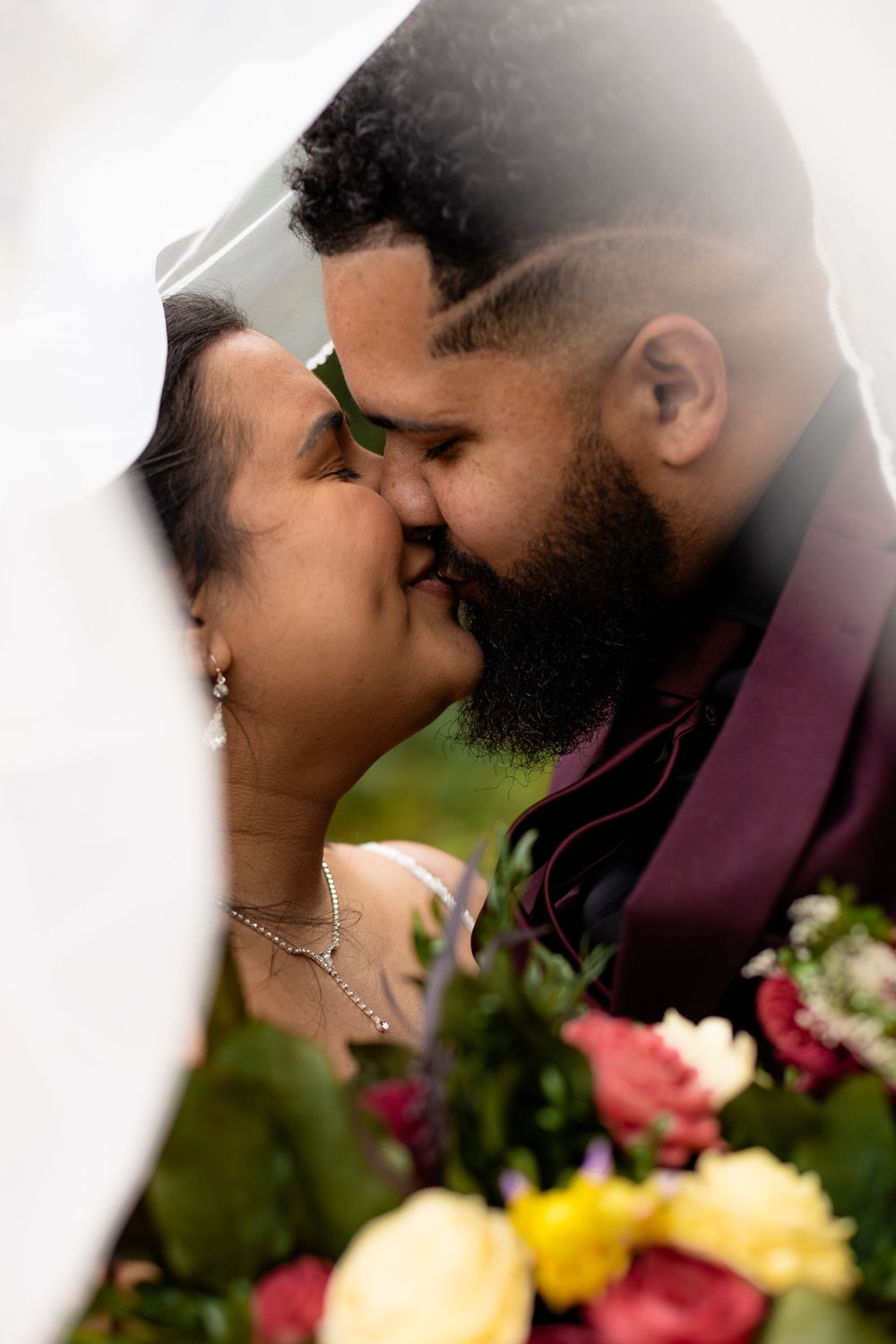 Dreamy soft-focus wedding portraits with floral bouquet in natural lighting.