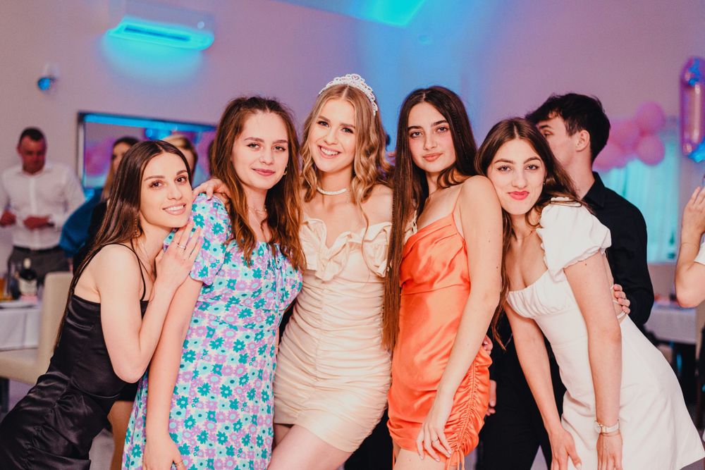 Festive party scene with colorful lighting and decorative elements.