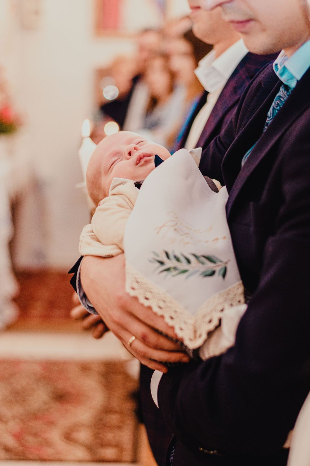 Row of hands holding white paper decorations at a formal event.