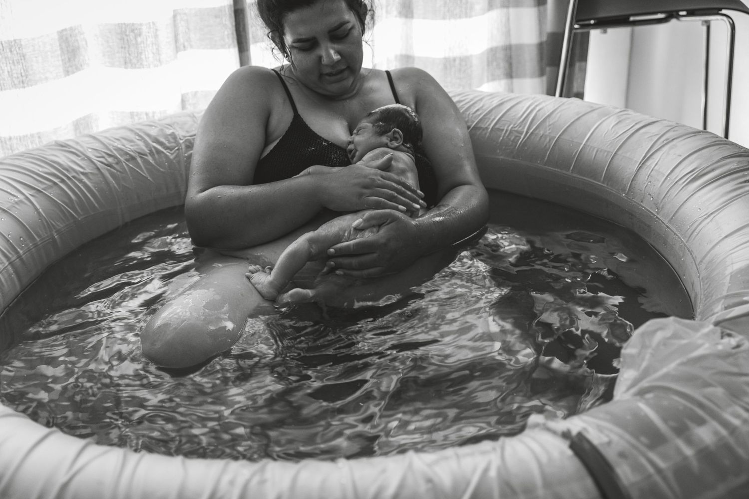 Person relaxing in birthing pool filled with water. Photographer. Hull. East Yorkshire. Photography