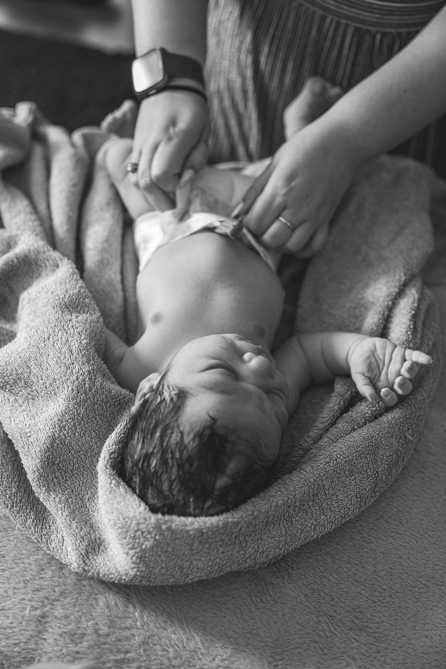Black and white photo of a newborn baby lying on a towel during care. Photographer. Hull. East Yorkshire. Photography