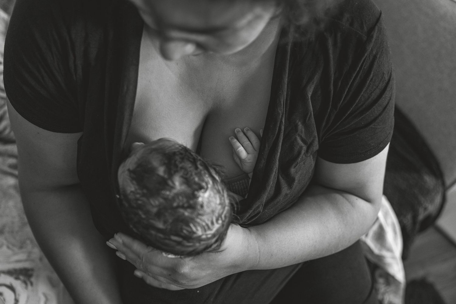 Black and white image showing gentle care of a newborn. Photographer. Hull. East Yorkshire. Photography