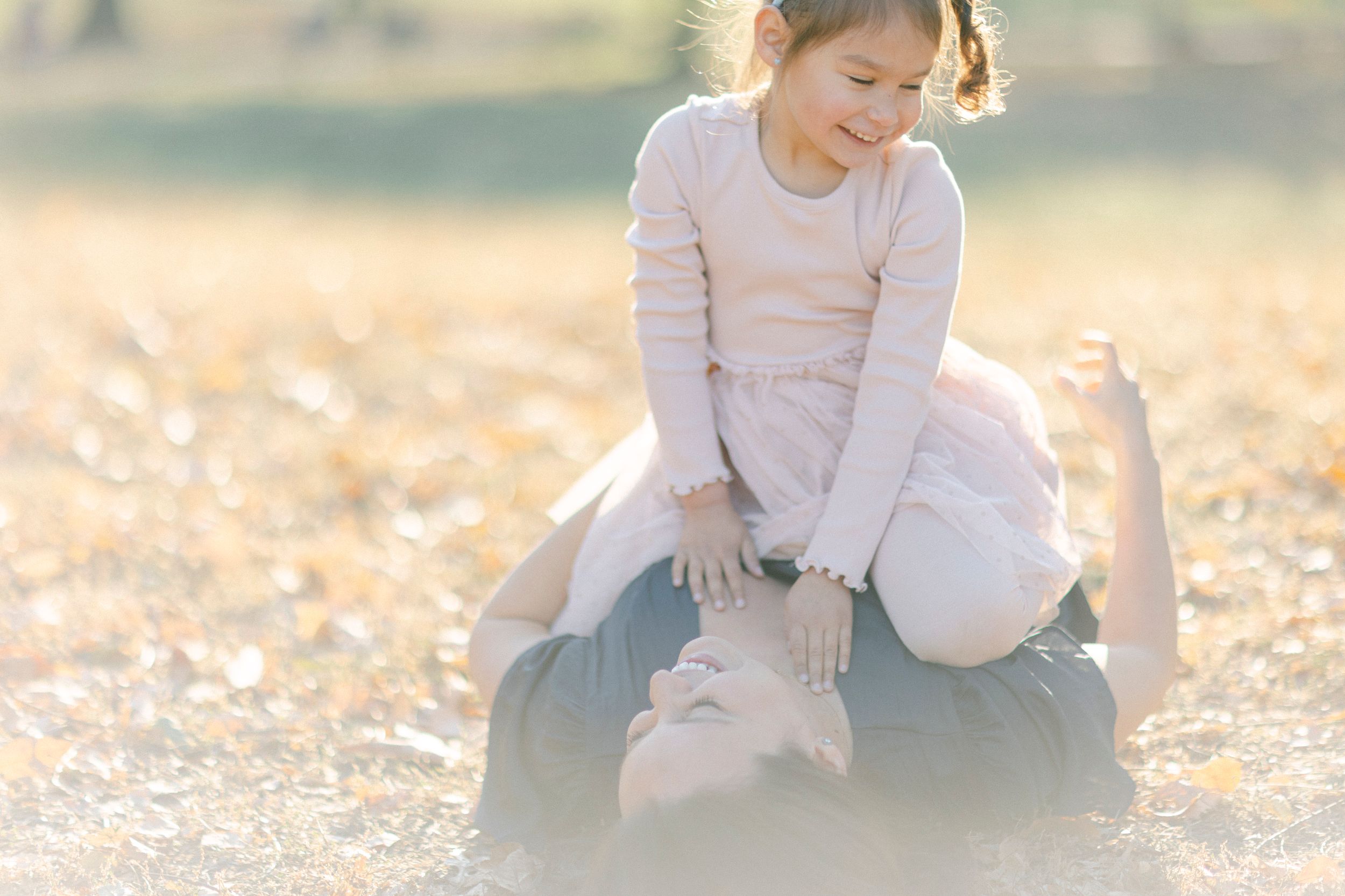 A playful interaction between two figures in warm afternoon sunlight.