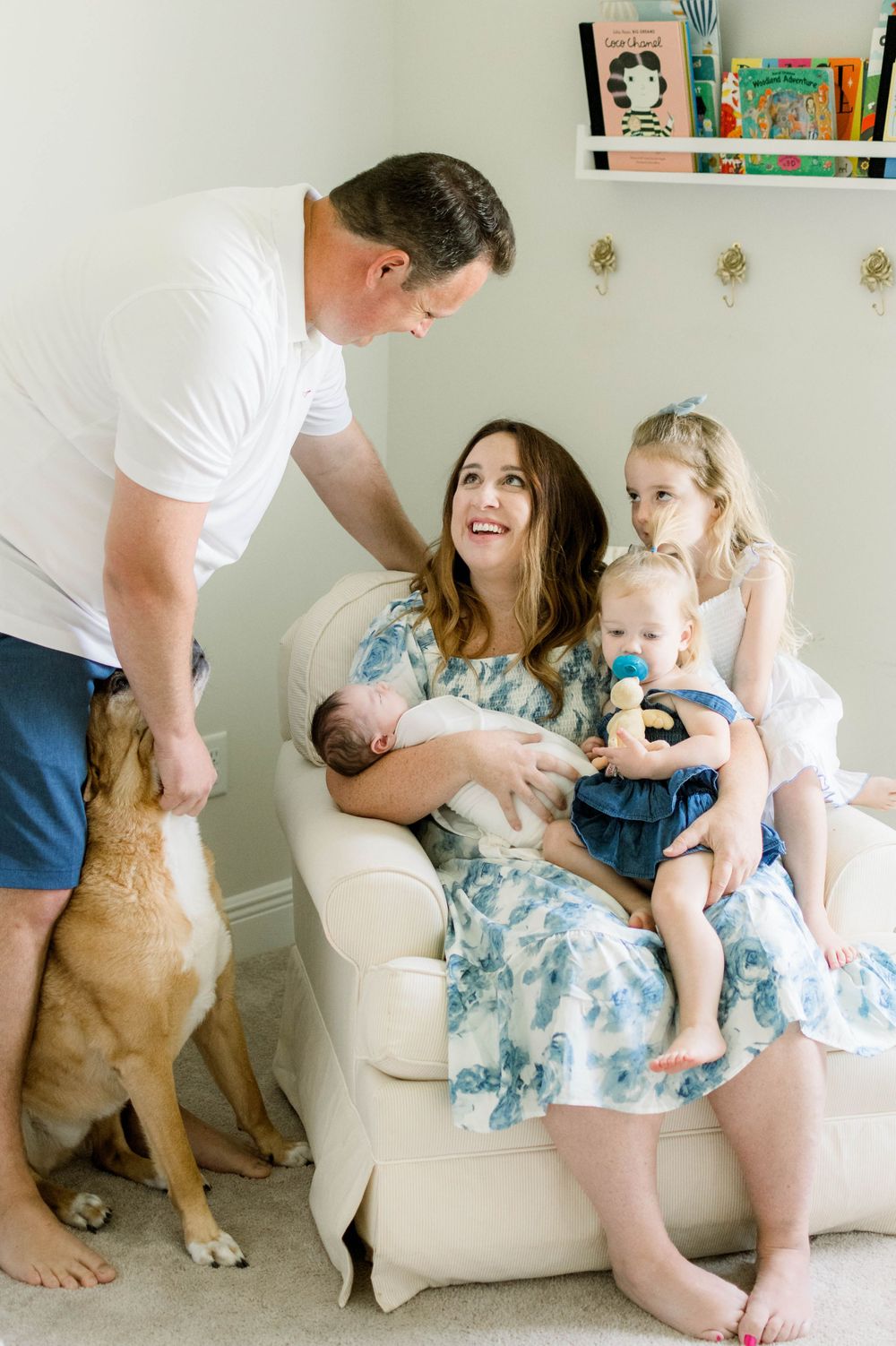 Family gathering in a cozy living room with a dog beside them.