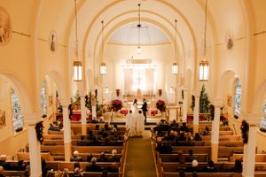 Beautiful church interior with arched ceiling and aisle during a wedding ceremony.