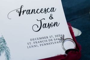 Wedding invitation featuring elegant calligraphy with couple's names and ceremony details.