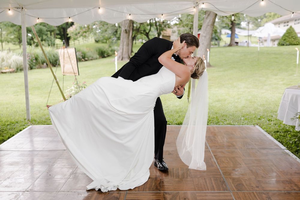 Professional wedding photographs taken outdoors at an elegant venue with couples dancing and posing under a white tent.