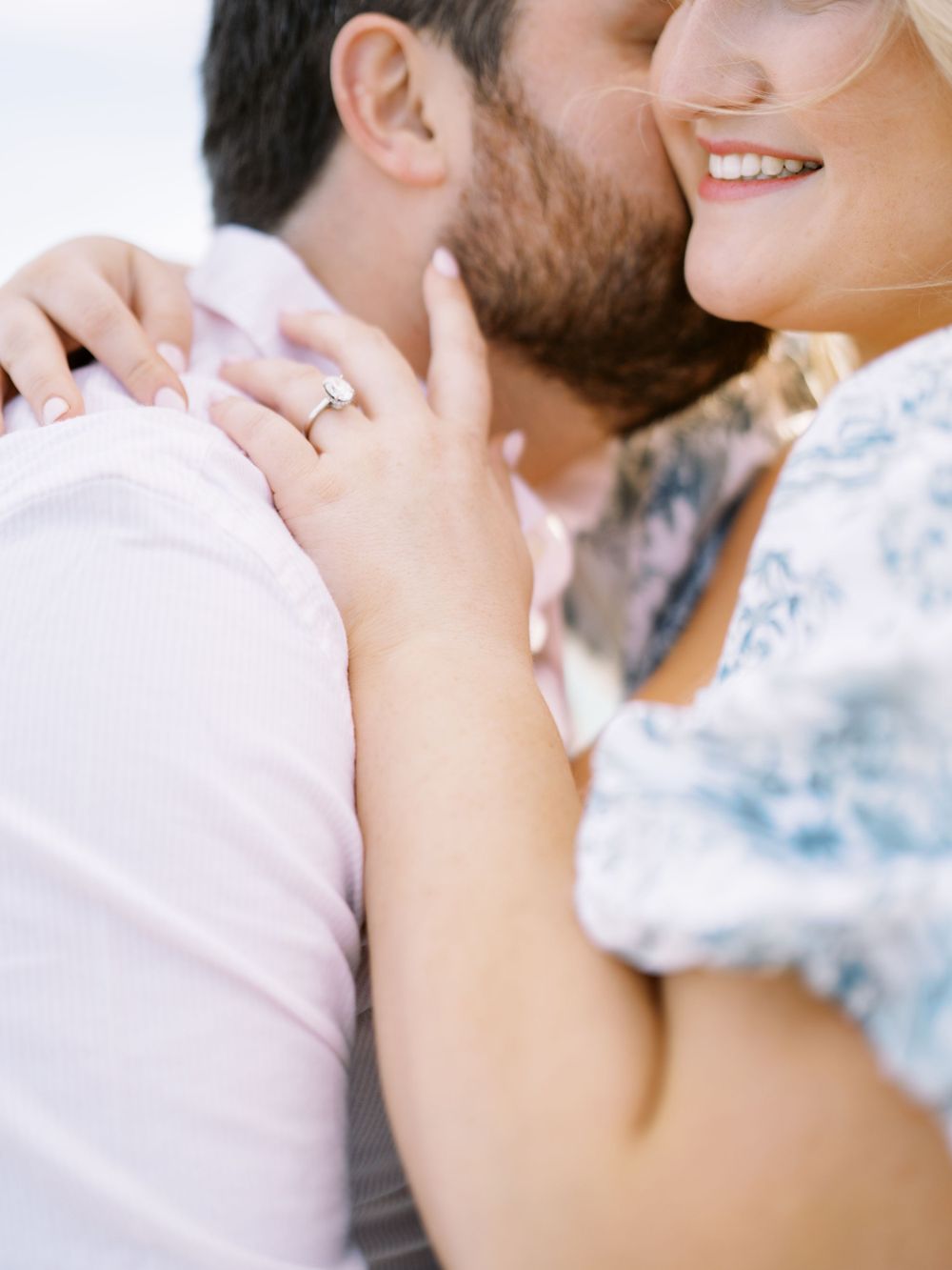 A close-up romantic moment showing a wedding ring and tender embrace.