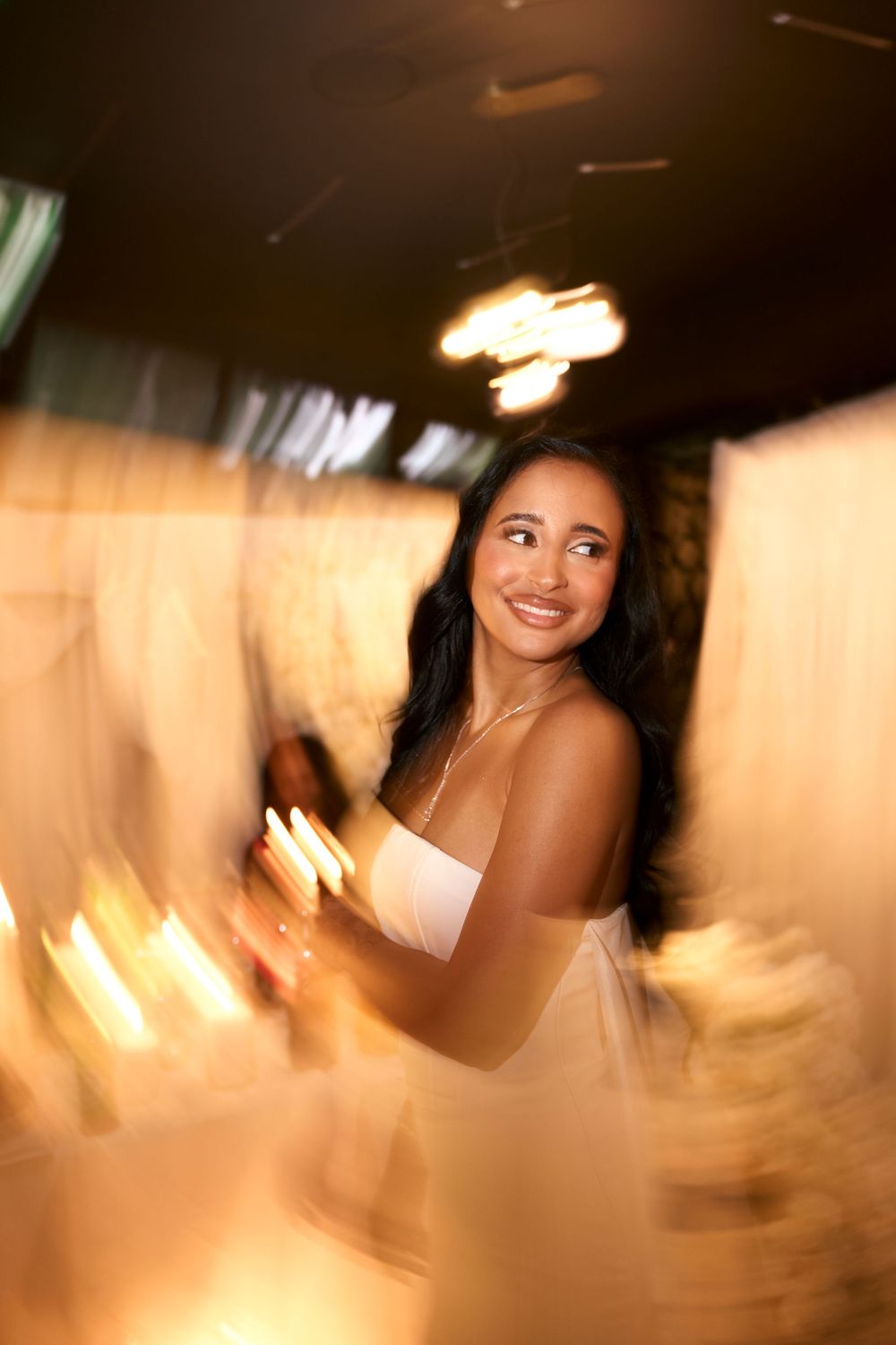 Artistic wedding portrait with warm tones and radial blur effect.
