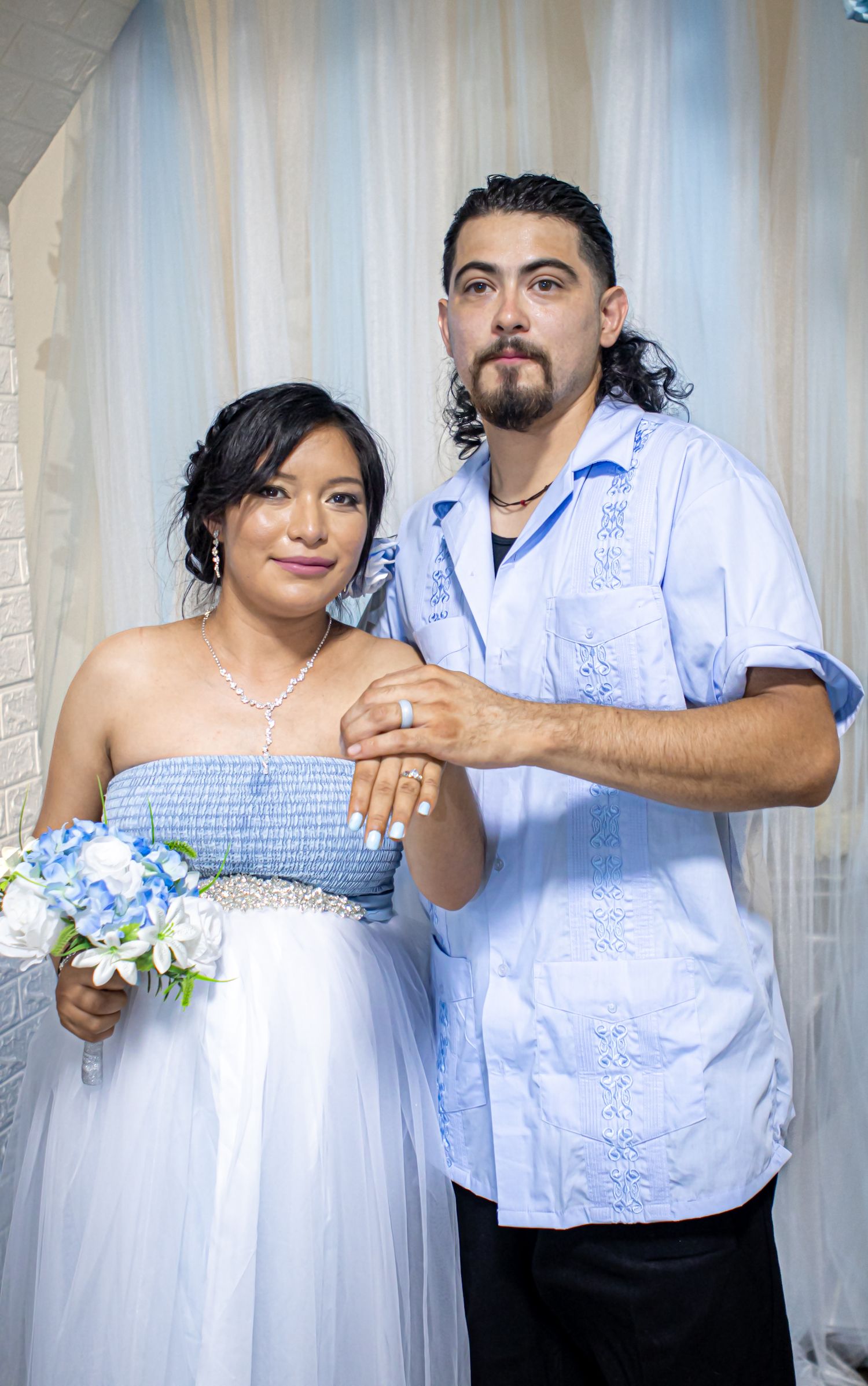 Bride and groom showing their rings