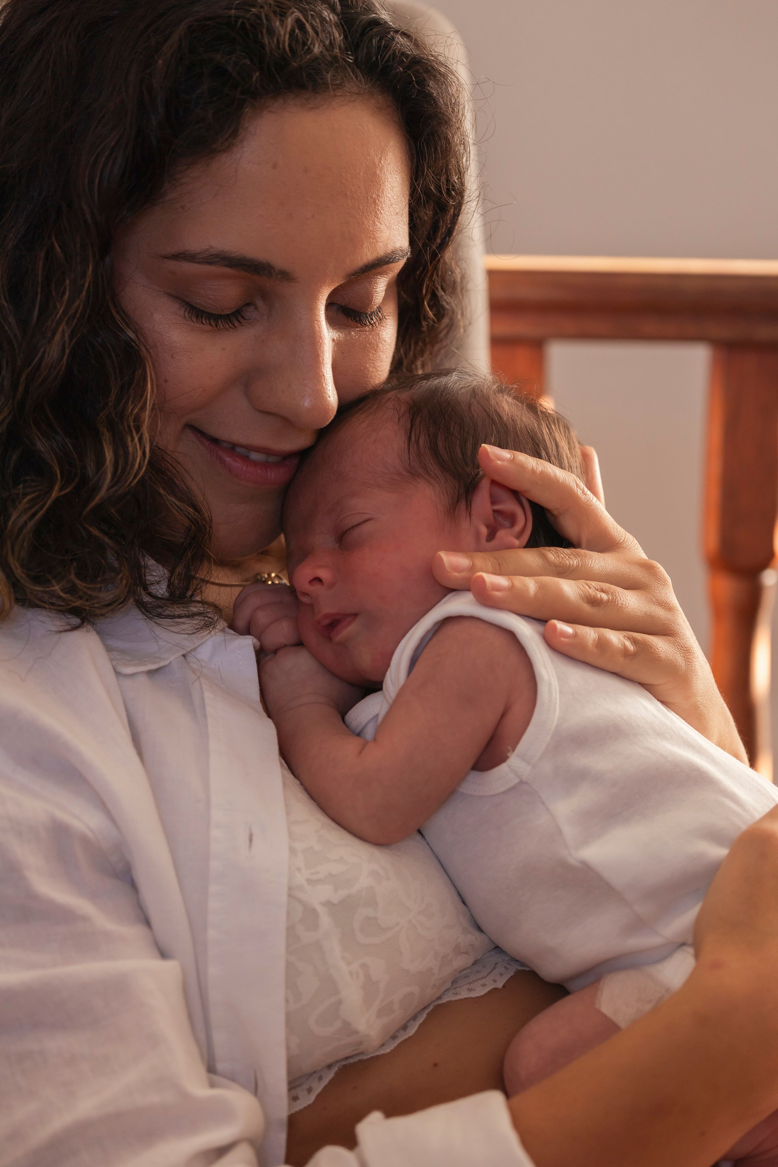 A tender moment between parent and child sharing loving embraces and smiles in a warm, intimate setting.