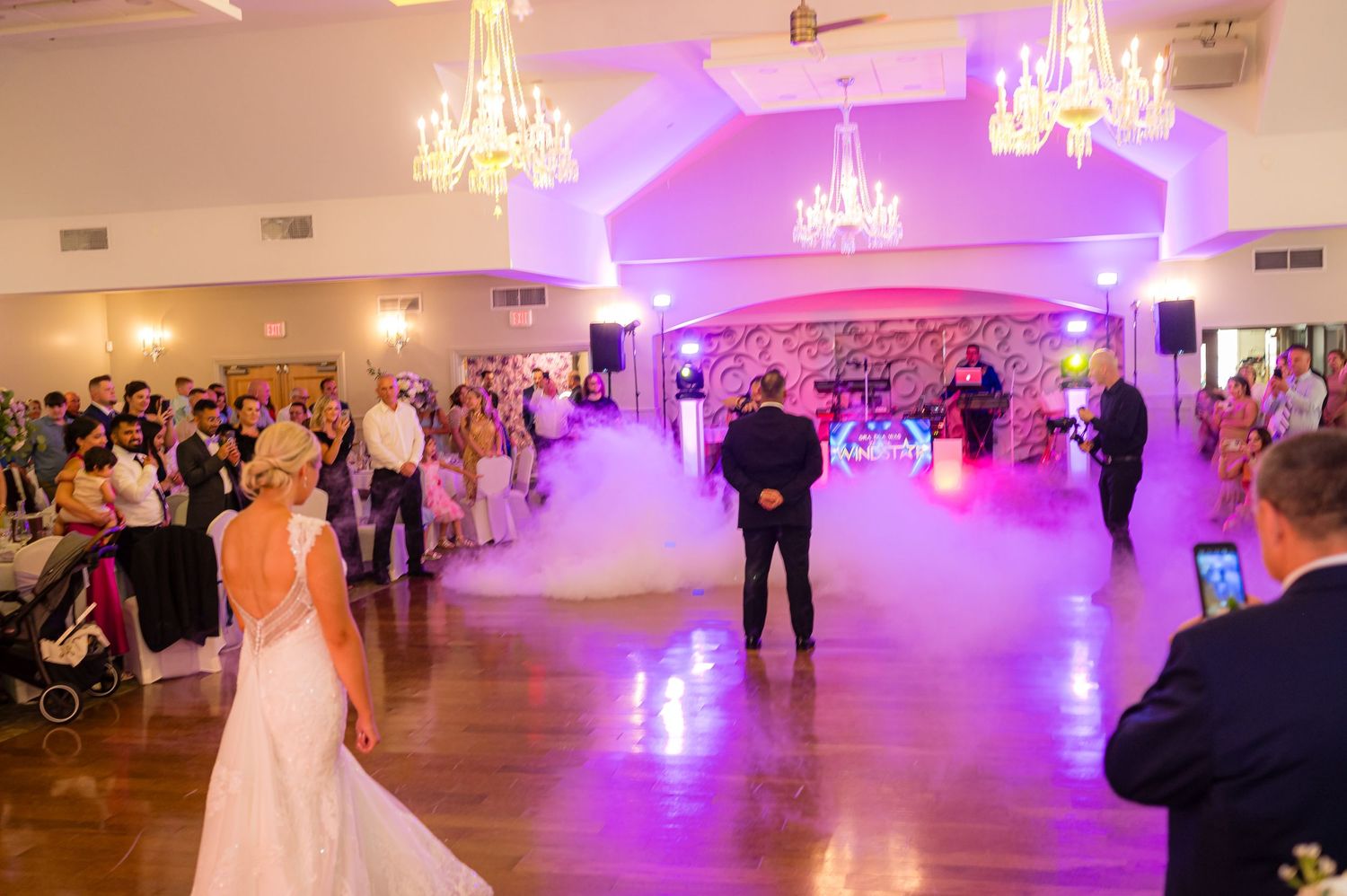 DANCING NEWLY MARRIED  COUPLE AT A WEDDING WITH FOG ON THE DANCE FLOOR.