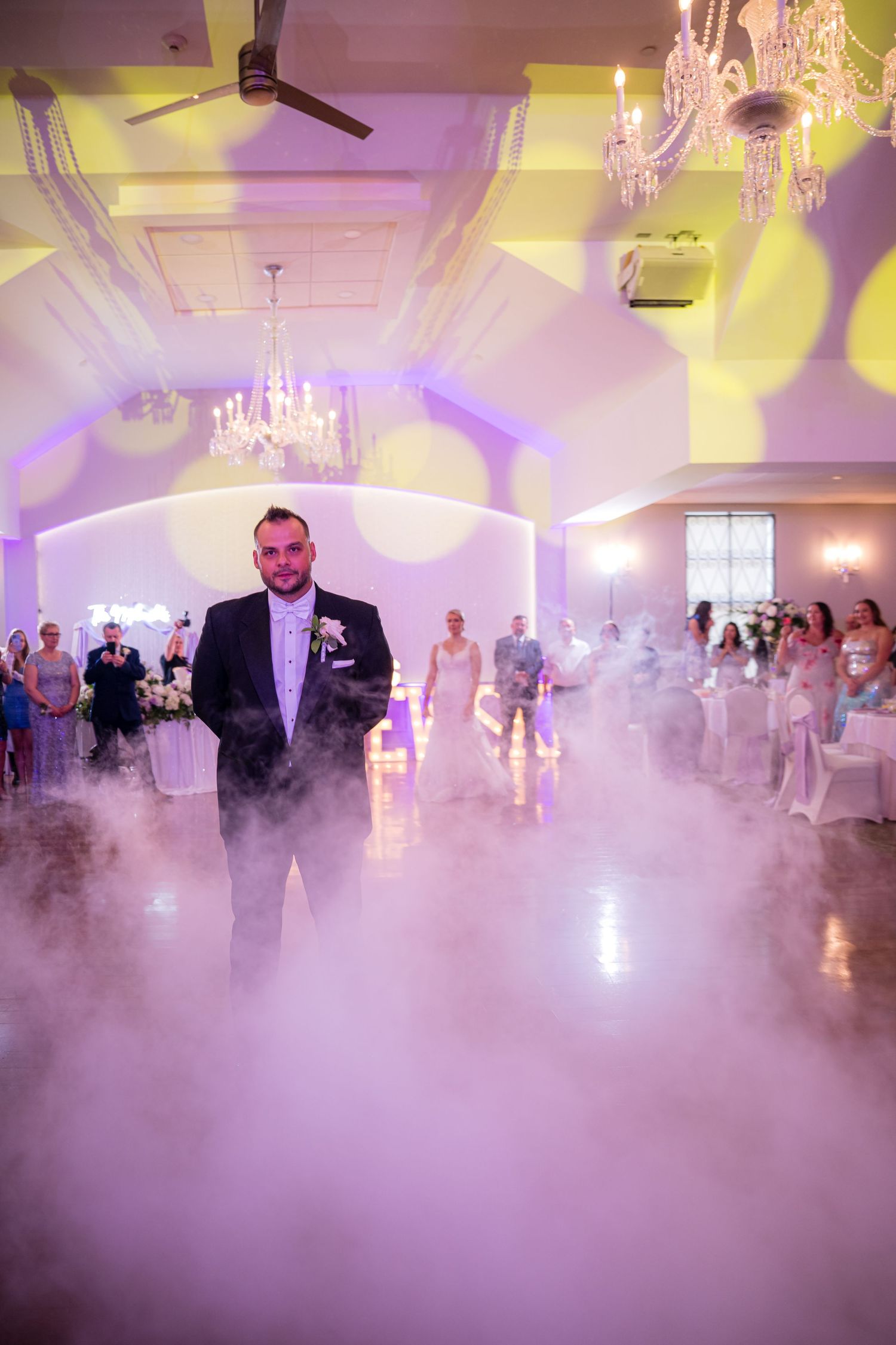 DANCING NEWLY MARRIED  COUPLE AT A WEDDING WITH FOG ON THE DANCE FLOOR.