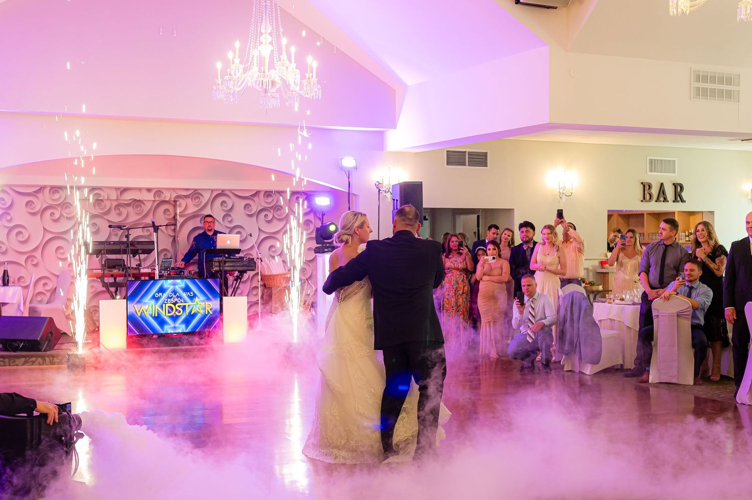 DANCING NEWLY MARRIED  COUPLE AT A WEDDING WITH FOG ON THE DANCE FLOOR.