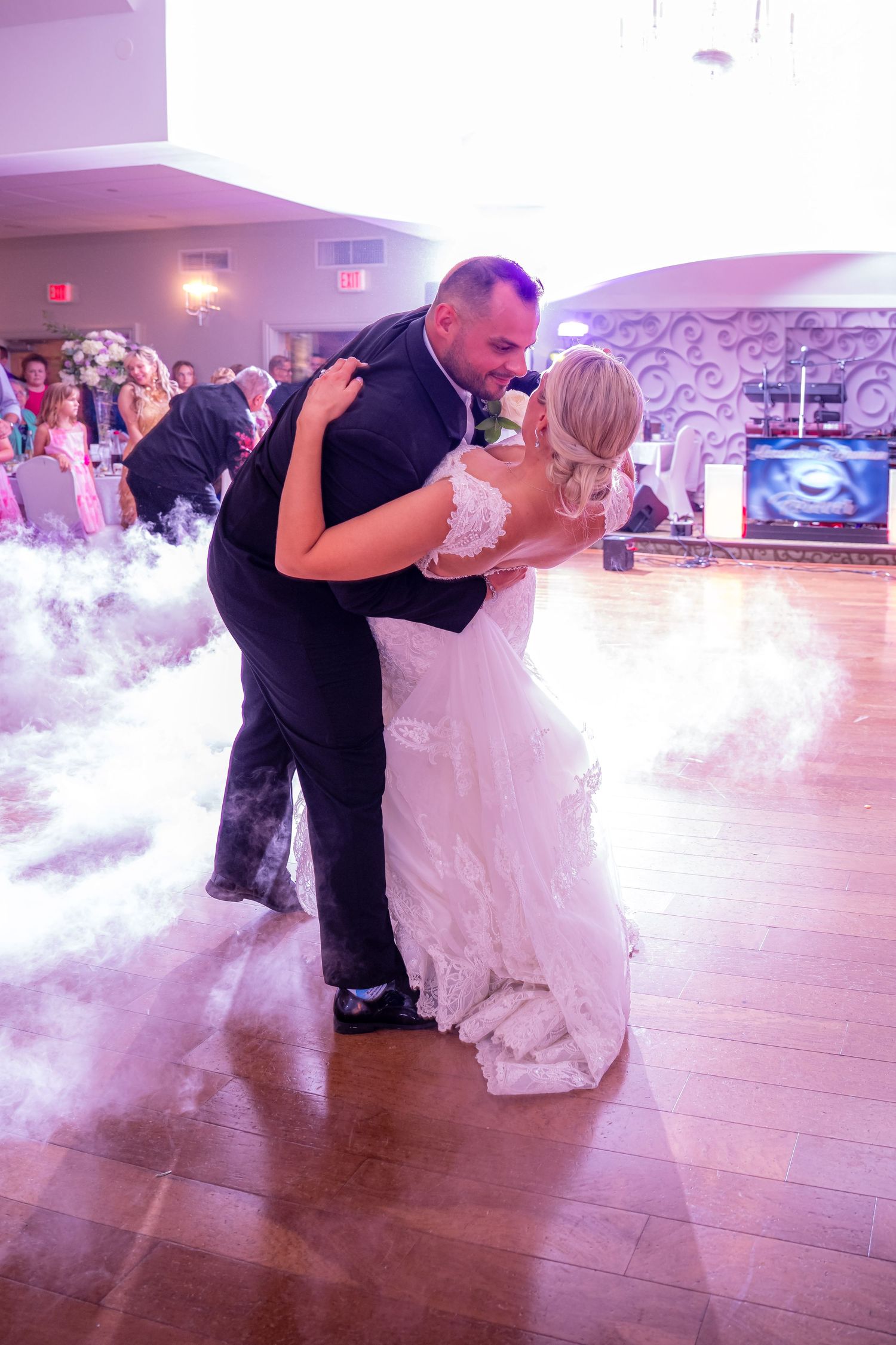 DANCING NEWLY MARRIED  COUPLE AT A WEDDING WITH FOG ON THE DANCE FLOOR.
