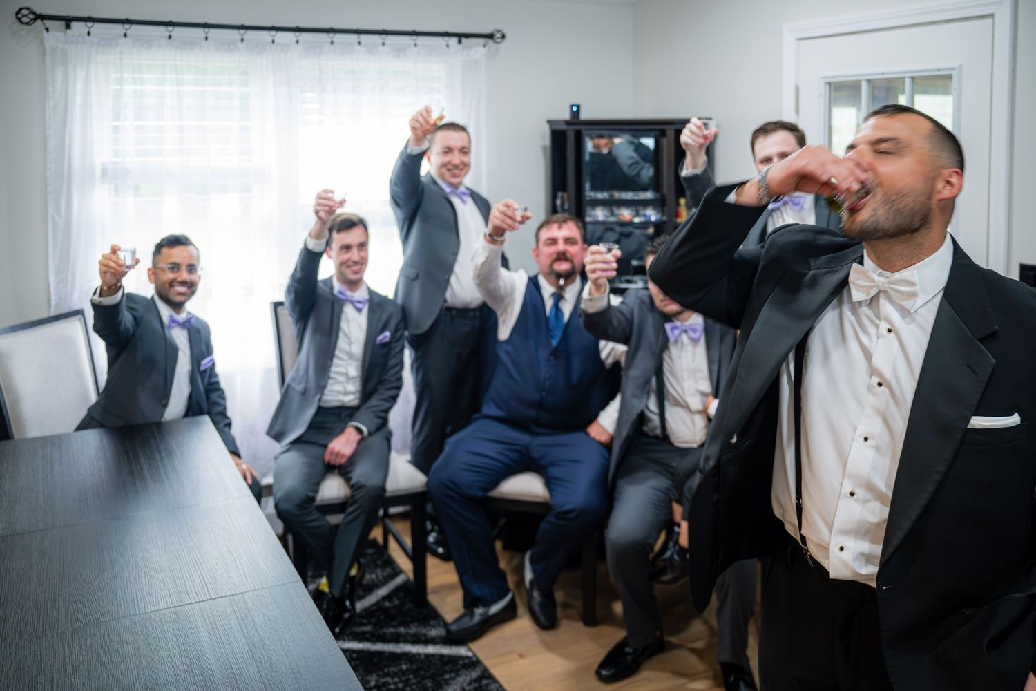 GUYS GETTING READY FOR THE WEDDING  AS THEY ARE DRINKING VODKA SHOTS