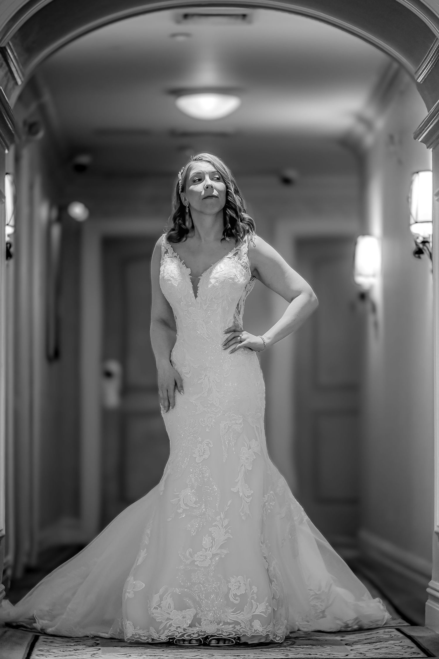 BLACK AND WHITE BRIDE LOOKING UP WITH HER BEAUTIFUL DRESS