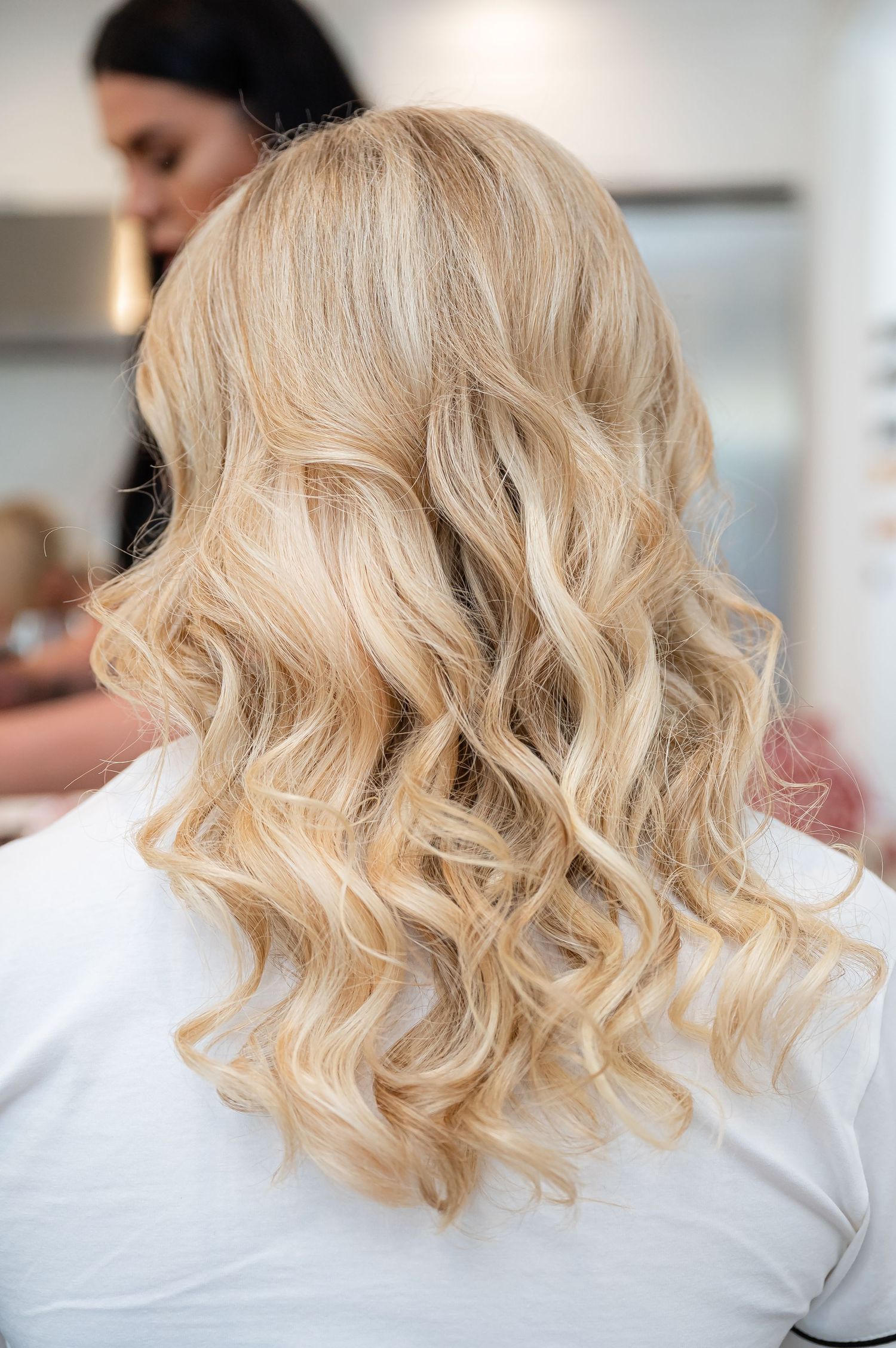 Close-up views of blonde wavy hair styled in a modern shoulder-length bob cut.